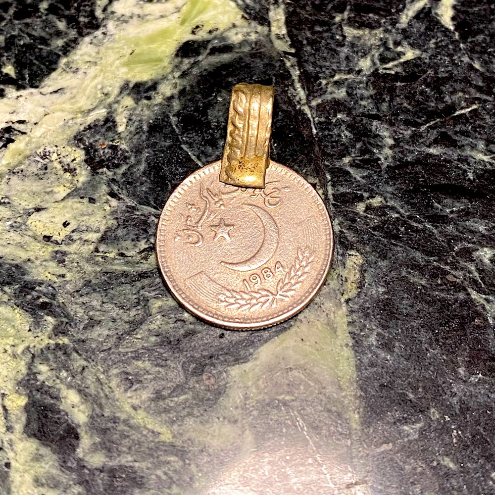 Super cute repurposed coin as a necklace pendant.
